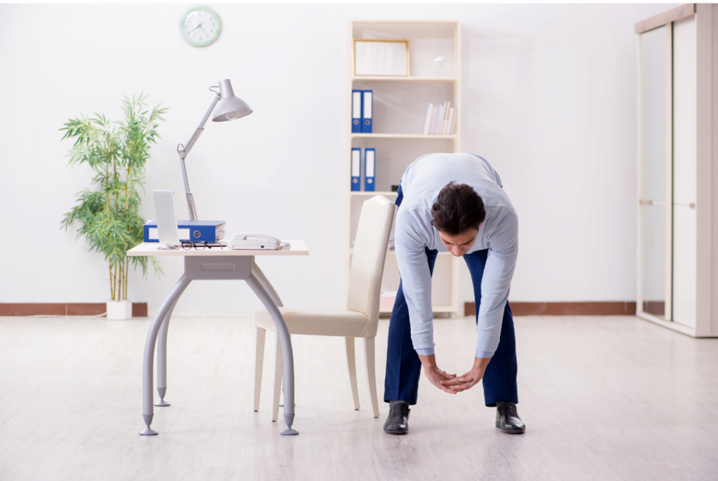 A man doing exercise at his desk e1664577127100